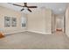 Bedroom featuring neutral carpet and walls with many windows and plantation shutters at 1608 W Calle De Pompas --, Phoenix, AZ 85085