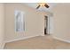A neutral bedroom with a ceiling fan and bright windows with coverings at 1608 W Calle De Pompas --, Phoenix, AZ 85085