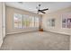 Bedroom featuring neutral carpet and walls with many windows and plantation shutters at 1608 W Calle De Pompas --, Phoenix, AZ 85085