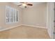Bright bedroom featuring neutral walls, carpet floors, and plantation shutters at 1608 W Calle De Pompas --, Phoenix, AZ 85085