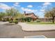 Charming clubhouse exterior with lush landscaping, providing a welcoming community gathering space at 1608 W Calle De Pompas --, Phoenix, AZ 85085