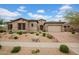 Charming home featuring a stone facade, a paver driveway, and desert landscaping in a well-maintained front yard at 1608 W Calle De Pompas --, Phoenix, AZ 85085