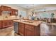 A kitchen island with granite counters complements dark cabinets and stainless steel appliances at 1608 W Calle De Pompas --, Phoenix, AZ 85085