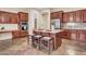 Elegant kitchen with a center island, granite countertops, stainless steel appliances, and custom cabinetry at 1608 W Calle De Pompas --, Phoenix, AZ 85085