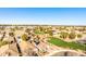 Presents a panoramic view of a well-planned community with lush green lawns and varied home styles at 17704 W Tasha Dr, Surprise, AZ 85388
