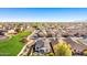 An aerial shot of a residential area, showcasing homes with solar panels and landscaped yards at 17704 W Tasha Dr, Surprise, AZ 85388