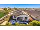 Aerial view of home featuring a solar-paneled roof, landscaped yard, and a private backyard pool at 17704 W Tasha Dr, Surprise, AZ 85388