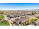 This photo highlights a sprawling community, revealing an array of residences and distant mountain views at 17704 W Tasha Dr, Surprise, AZ 85388