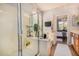 Bright bathroom with a glass shower, tile floors, and a door to the main bedroom at 17704 W Tasha Dr, Surprise, AZ 85388