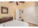 Cozy bedroom with neutral walls, wood-look floors, closet, and coastal-themed decor at 17704 W Tasha Dr, Surprise, AZ 85388