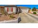 Charming single-Gathering house featuring a two-car garage, low maintenance yard, and white picket fence at 17704 W Tasha Dr, Surprise, AZ 85388