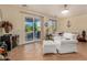 Cozy living room with tile flooring, comfortable white seating, and sliding glass doors at 17704 W Tasha Dr, Surprise, AZ 85388