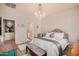 Bright main bedroom featuring a chandelier, an ensuite and an accent dresser at 17704 W Tasha Dr, Surprise, AZ 85388