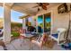 Covered patio with outdoor dining set, seating, and a ceiling fan at 17704 W Tasha Dr, Surprise, AZ 85388