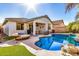 Backyard pool and patio area perfect for relaxing, with outdoor seating and lush landscaping at 17704 W Tasha Dr, Surprise, AZ 85388