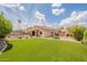 A well-manicured backyard featuring lush artificial turf, pool, seating, and outdoor pergola at 1919 S Granite St, Gilbert, AZ 85295