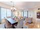 Formal dining area boasts a chandelier, six chairs, and a seamless flow into the living spaces at 1919 S Granite St, Gilbert, AZ 85295