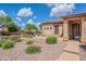 Charming single-story home with a well-manicured front yard and desert landscaping under a bright, sunny sky at 1919 S Granite St, Gilbert, AZ 85295
