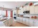Modern kitchen features white cabinetry, stainless steel appliances, and breakfast nook with lots of light at 1919 S Granite St, Gilbert, AZ 85295