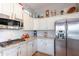 Modern kitchen featuring stainless steel appliances, white cabinetry, and decorative backsplash at 1919 S Granite St, Gilbert, AZ 85295