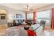 Comfortable living room featuring a ceiling fan, large windows, and stylish furnishings at 1919 S Granite St, Gilbert, AZ 85295
