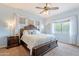 Luxurious main bedroom with a decorative ceiling fan, a large window, and refined furnishing at 1919 S Granite St, Gilbert, AZ 85295