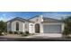 Charming home exterior with a neutral color palette, gray roof, and manicured landscaping at 20713 W San Miguel Ave, Buckeye, AZ 85396