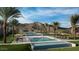 Stunning community pool area with palm trees and scenic mountain views, offering a resort-like experience at 20723 W San Miguel Ave, Buckeye, AZ 85396