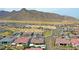 This is an aerial view of desert real estate featuring a private pool and mountain views at 20775 W Rattler Rd, Buckeye, AZ 85396