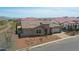 Aerial view of a neighborhood featuring desert landscaping, tile roofs and mountain views at 20775 W Rattler Rd, Buckeye, AZ 85396
