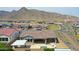 Panoramic aerial view of the home, neighboring properties, and mountain backdrop at 20775 W Rattler Rd, Buckeye, AZ 85396