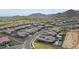 A great aerial view of a desert property, surrounded by neighboring homes at 20775 W Rattler Rd, Buckeye, AZ 85396