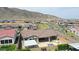 Aerial view of backyard with pool, patio, BBQ area and mountains in the background at 20775 W Rattler Rd, Buckeye, AZ 85396