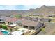 Stunning aerial view of home with a private pool, backyard fire pit, and mountain views at 20775 W Rattler Rd, Buckeye, AZ 85396