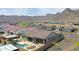 Stunning aerial view of home with a private pool, backyard fire pit, and mountain views at 20775 W Rattler Rd, Buckeye, AZ 85396