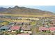 Community aerial view of neighborhood homes, streets, desert landscaping, and mountains in the background at 20775 W Rattler Rd, Buckeye, AZ 85396