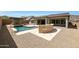 Stunning backyard with a pool, spa, outdoor fireplace, built-in BBQ, and low-maintenance desert landscaping at 20775 W Rattler Rd, Buckeye, AZ 85396