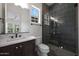 Modern bathroom featuring an undermount sink, and a beautiful glass shower with dark tiling at 20775 W Rattler Rd, Buckeye, AZ 85396