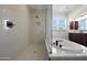 Spa-like bathroom with soaking tub, separate shower, and natural light at 20775 W Rattler Rd, Buckeye, AZ 85396