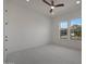 Bright bedroom featuring a ceiling fan, neutral carpet and two large windows at 20775 W Rattler Rd, Buckeye, AZ 85396
