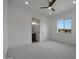 Bright, spacious bedroom with a ceiling fan, an en suite bathroom and a large window at 20775 W Rattler Rd, Buckeye, AZ 85396