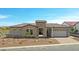 Beautiful single-Gathering home featuring a stone facade, paver driveway and desert-style landscaping at 20775 W Rattler Rd, Buckeye, AZ 85396