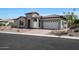 Beautiful single-Gathering home featuring a stone facade, two-car garage, and desert-style landscaping at 20775 W Rattler Rd, Buckeye, AZ 85396