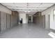 Spacious garage featuring epoxy floors and gray wood-tone cabinets on both sides for ample storage and organization at 20775 W Rattler Rd, Buckeye, AZ 85396