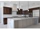 Bright, open kitchen with a large marble island, stainless steel appliances, and dark wood cabinets at 20775 W Rattler Rd, Buckeye, AZ 85396