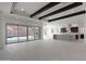 Bright living area featuring decorative ceiling beams, open layout, and seamless access to a pool area at 20775 W Rattler Rd, Buckeye, AZ 85396