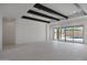 Bright, open living space featuring decorative ceiling beams and sliding glass doors, offering a view of the pool at 20775 W Rattler Rd, Buckeye, AZ 85396