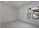 Sun-lit living space with neutral paint, recessed lights, and tile flooring at 20775 W Rattler Rd, Buckeye, AZ 85396