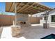 Outdoor living space with a covered patio, stone fireplace, and travertine tile, perfect for relaxation at 20775 W Rattler Rd, Buckeye, AZ 85396