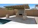 Outdoor living space with a covered patio and stone fireplace, ideal for entertaining and relaxing at 20775 W Rattler Rd, Buckeye, AZ 85396